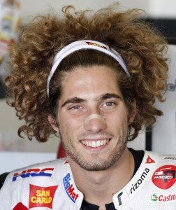 FILE - In this Sept. 2, 2011 file photo, Italy's Marco Simoncelli smiles at the pit during a first free practice session of the San Marino MotoGP grand prix at the Misano circuit, in Misano Adriatico, Italy.  Italian rider Simoncelli died after an accident at the Malaysian MotoGP, organizers say.  (AP Photo/Antonio Calanni, File)